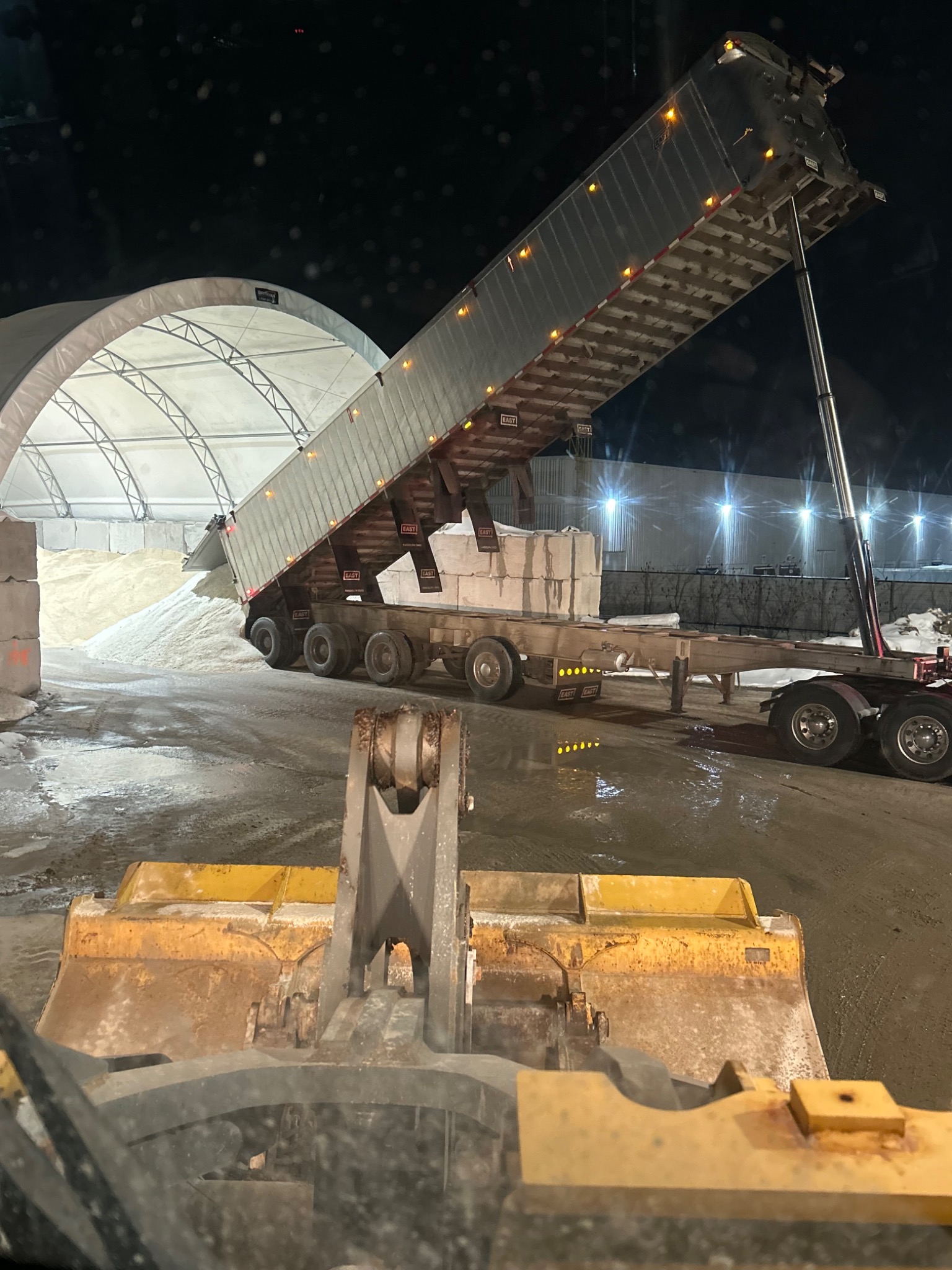 Bulk salt delivery unloading at night during the winter season